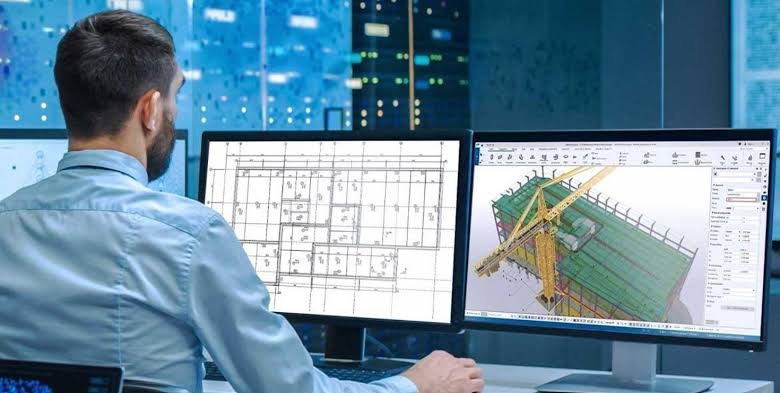Engineer working on Tekla structural modeling across dual monitors